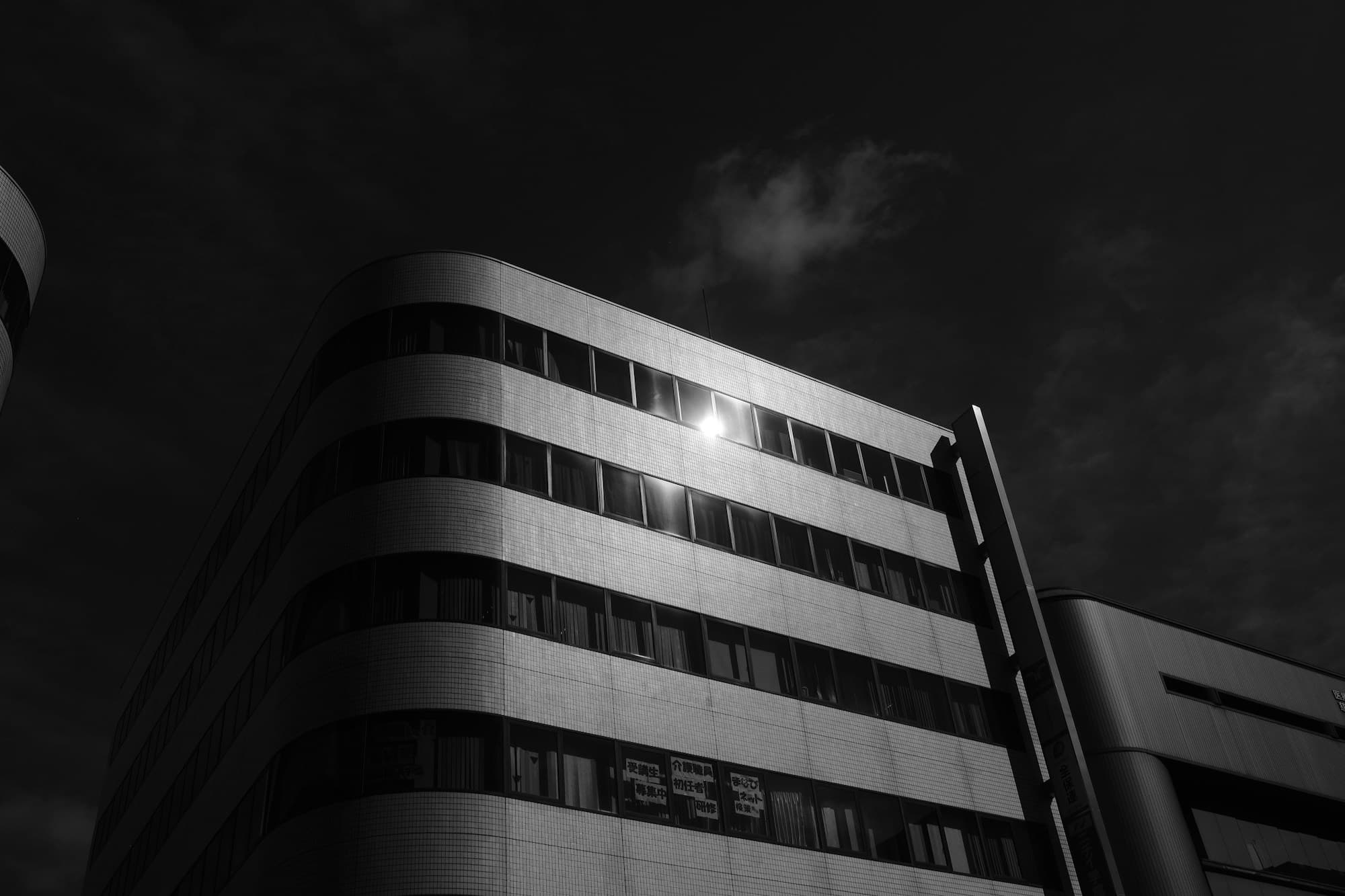 Modern building facade against a dark sky at night